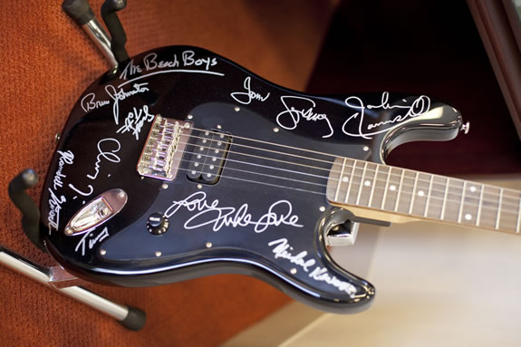 Patrick Kelly prizes a guitar signed by the Beach Boys.<br /><em>Photo by Stephanie Diani</em>