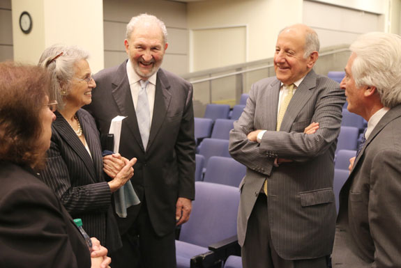Former Chief Justice Ronald M. George (arms folded) chats with award recipients after the ceremony. To George