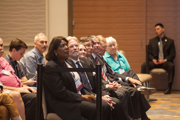 Board of Trustees members Danette E. Meyers, Mark A. Broughton, Joanna Mendoza, Richard Ramirez, Sean SeLegue, Alan Steinbrecher and Janet Brewer listen to the chief justice’s remarks. <em> Photo by S. Todd Rogers </em>